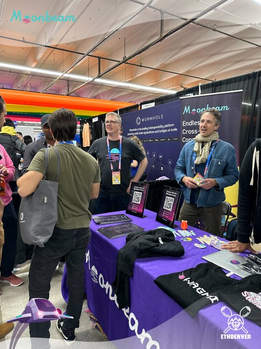 Community members engaged in conversation at the Moonbeam booth during ETH Denver